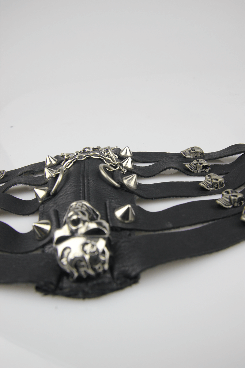 Black synthetic leather mask with silver spikes and skull accents, perfect for steampunk fashion and gothic style.