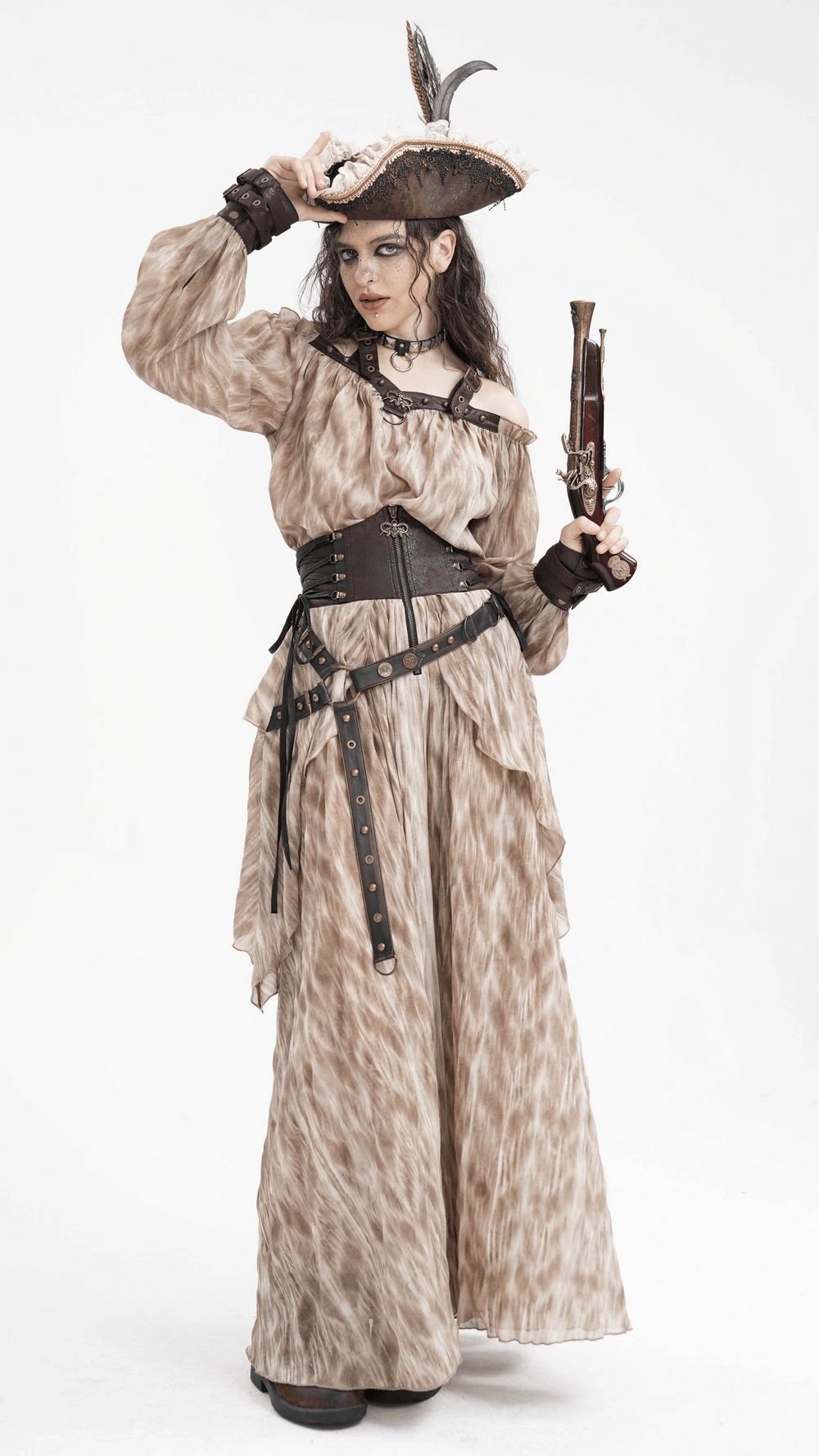 Steampunk-inspired model in layered maxi skirt and corset belt, wearing a pirate hat and holding a pistol.