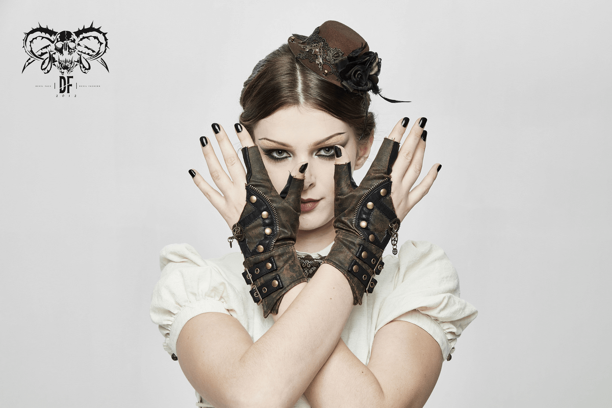 Stylish woman in steampunk leather gloves with rivets, showcasing a unique fashion statement.