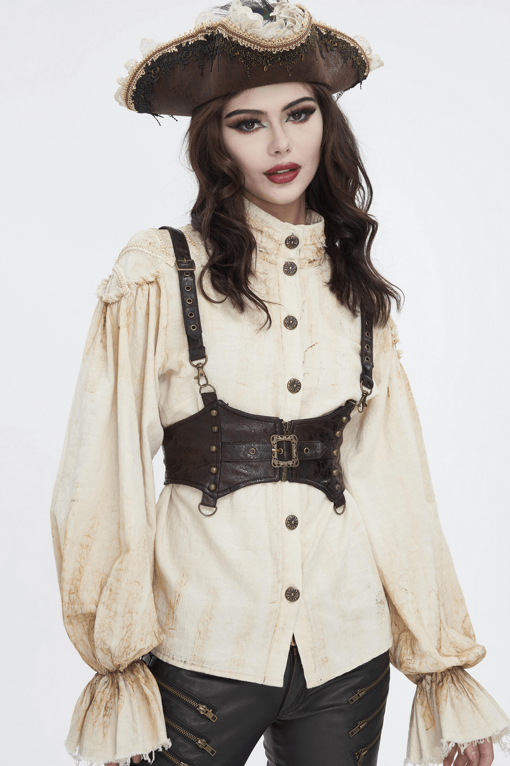 Woman in pirate hat wearing a steampunk leather harness and a vintage shirt for a gothic look.
