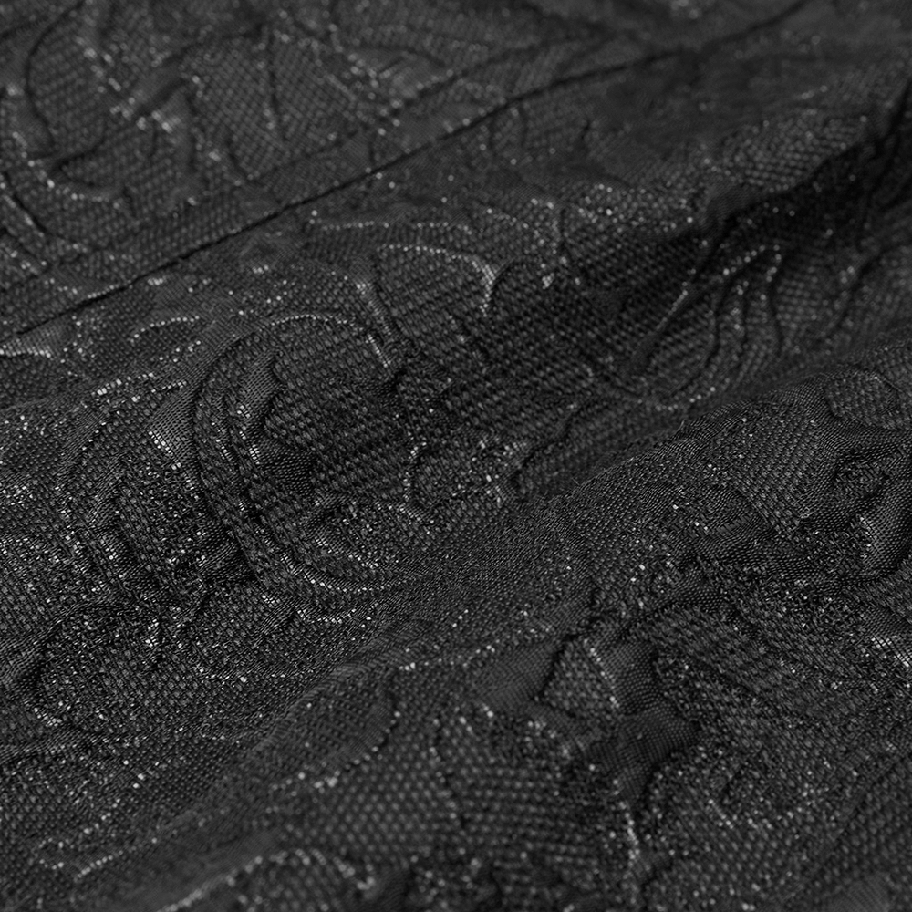 Close-up of black embroidered floral pattern on steampunk waistcoat fabric, showing intricate vintage details in velvet.