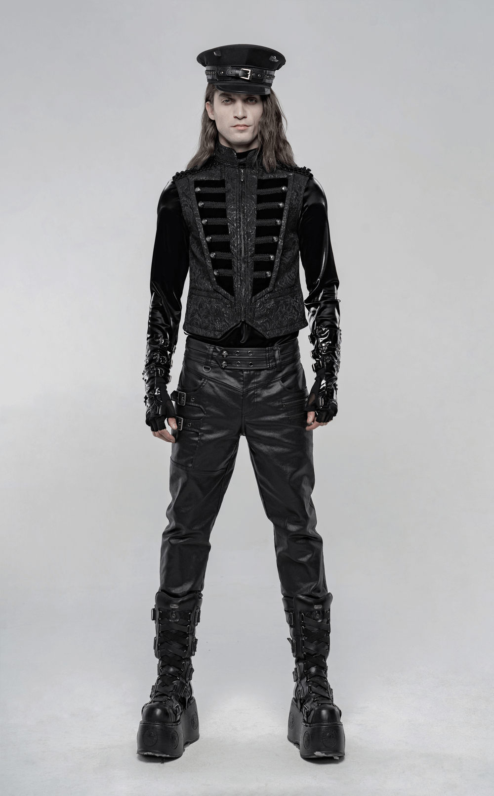 Steampunk male model in black velvet waistcoat with floral embroidery and high collar, embodying Victorian elegance and sophistication.