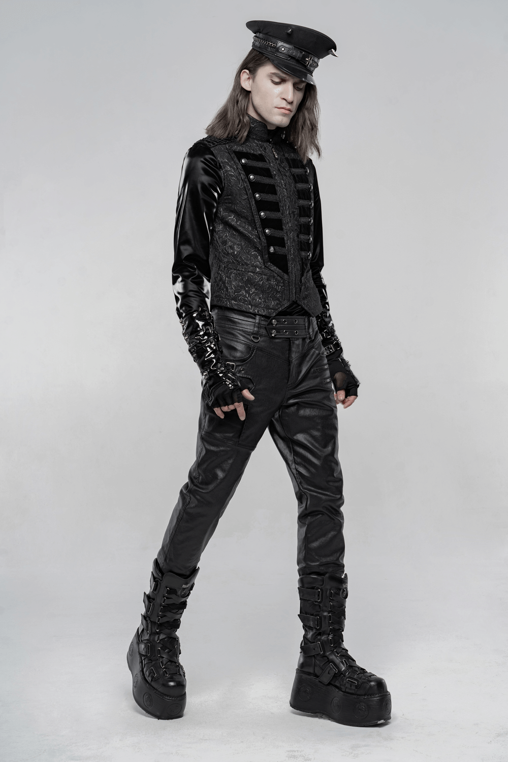 Steampunk male model in black velvet waistcoat with stand collar, Victorian-inspired style, showcasing embroidered floral design.