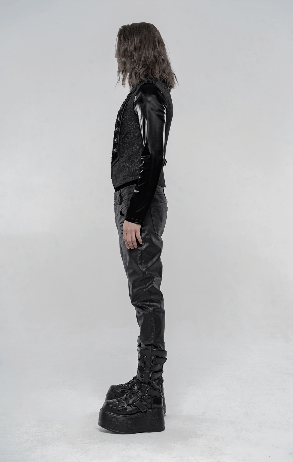 Steampunk black embroidered velvet waistcoat with high collar, side view, paired with dark trousers and platform boots
