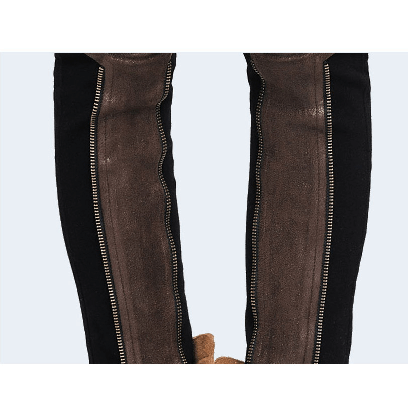 Close-up of steampunk pants with brown PU leather inserts and copper zips, showcasing a unique gothic style.