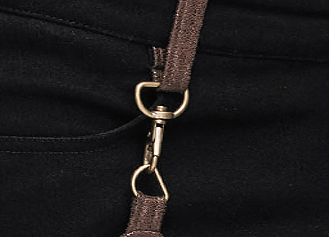 Close-up of steampunk pants featuring a stylish PU leather pocket and metal fastening detail.