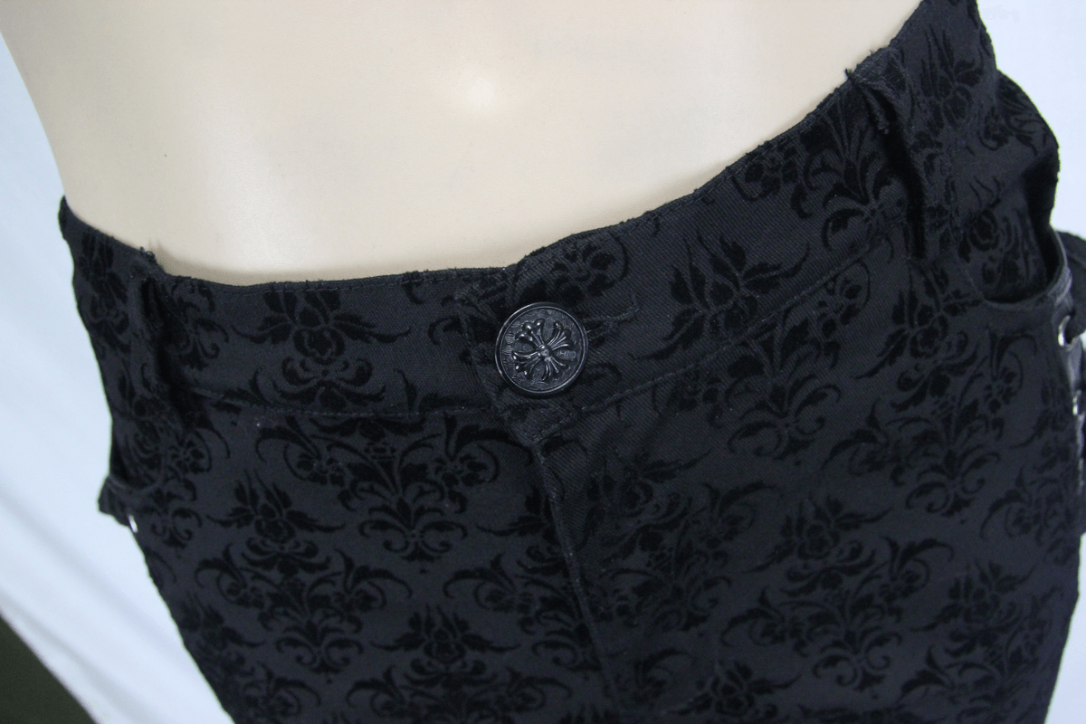 Close-up of the button detail on men's gothic black slim pants with elegant vintage print design.