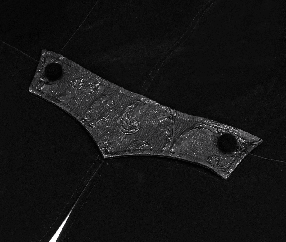 Close-up of decorative black velvet coat detail with silver buttons in steampunk style.