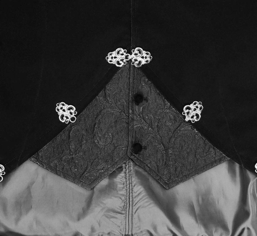 Close-up of black velvet steampunk coat featuring decorative silver buttons and intricate fabric details.