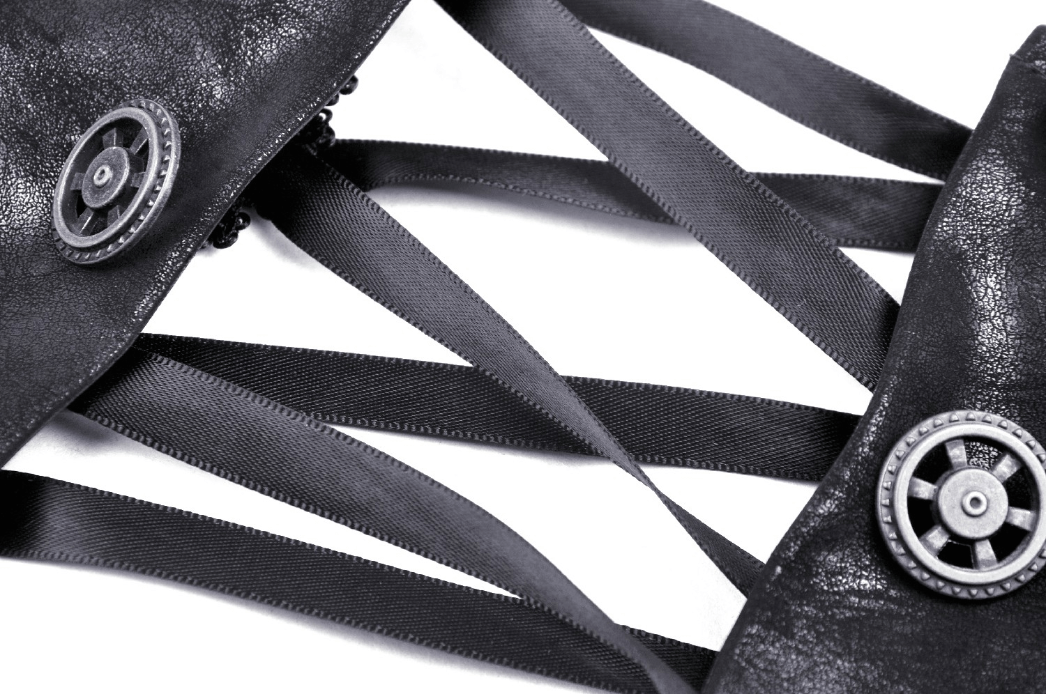 Close-up of black PU leather with corset lacing and industrial buttons for steampunk fashion.