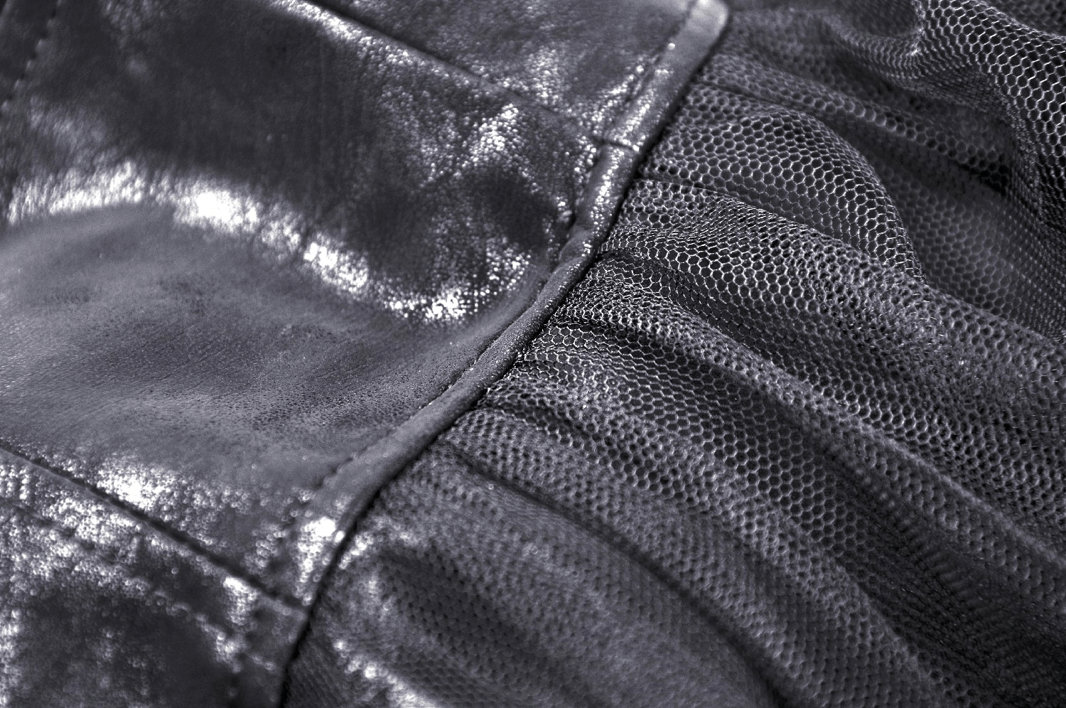 Close-up of black PU leather and lace fabric showing texture and detailing of a steampunk skirt.