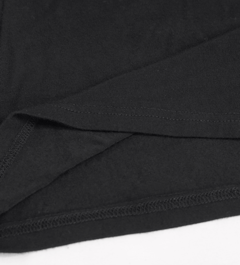 Close-up of the hem and fabric texture of a women's black steampunk tank top with spikes.