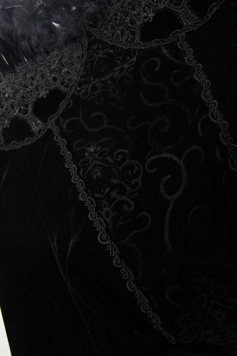 Close-up of a black steampunk dress featuring intricate lace detailing and elegant velvet fabric.
