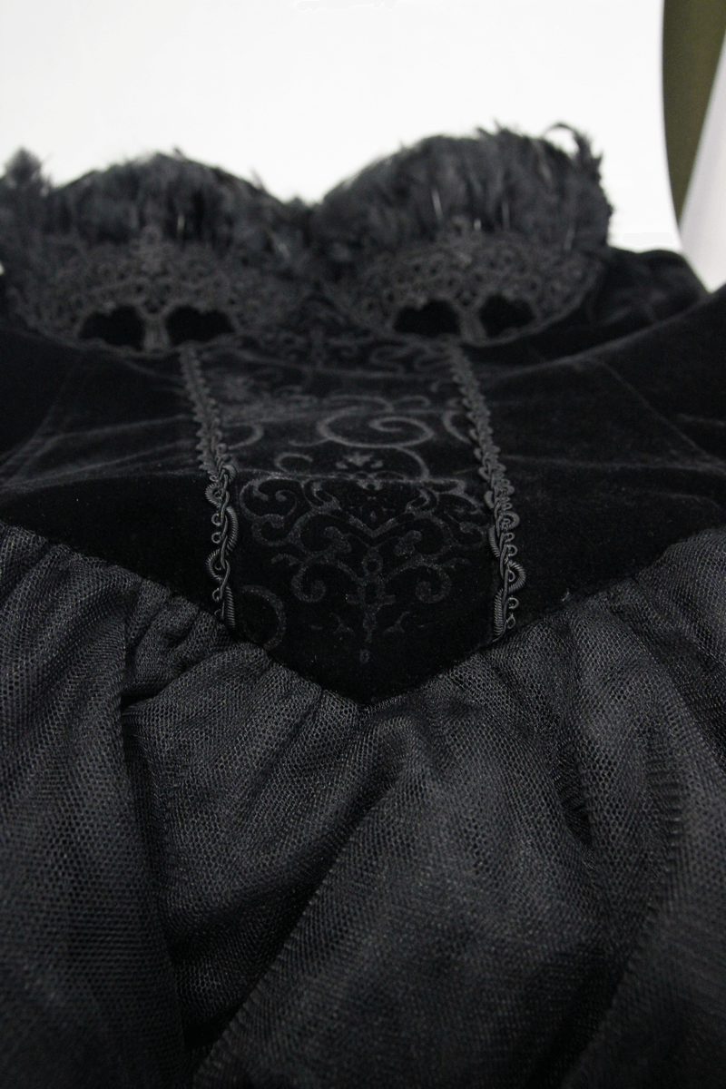 Close-up of elegant black strapless dress with lace and feather details, perfect for a gothic steampunk look.