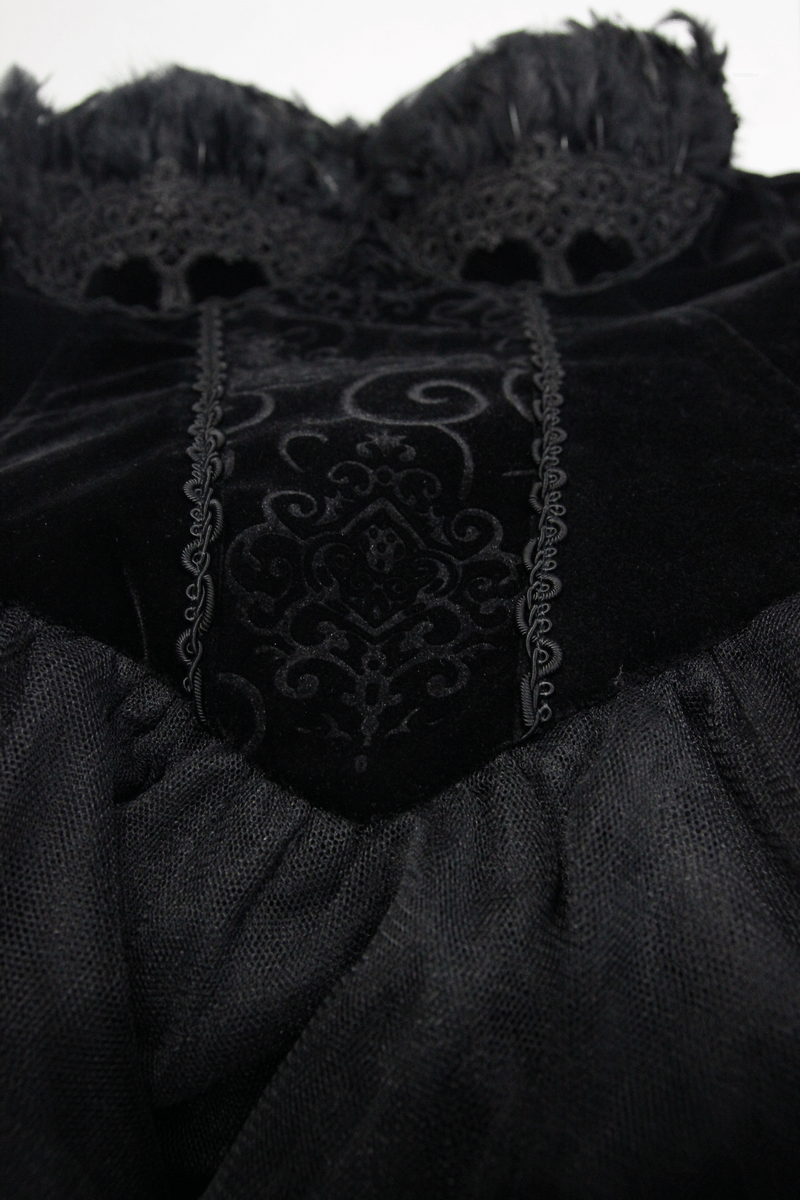 Close-up of a black strapless dress with lace detailing and feather trim, showcasing elegant steampunk design.