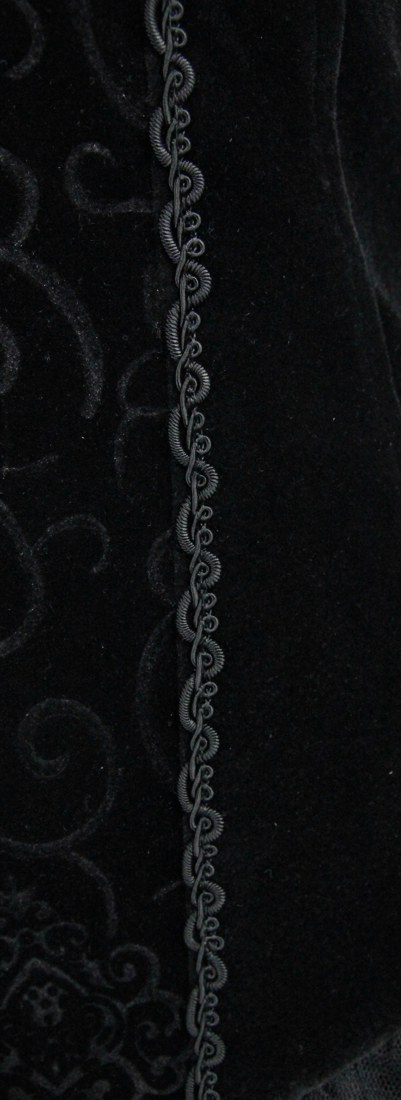 Close-up of lace detailing on a black strapless dress, showcasing elegant steampunk design elements.