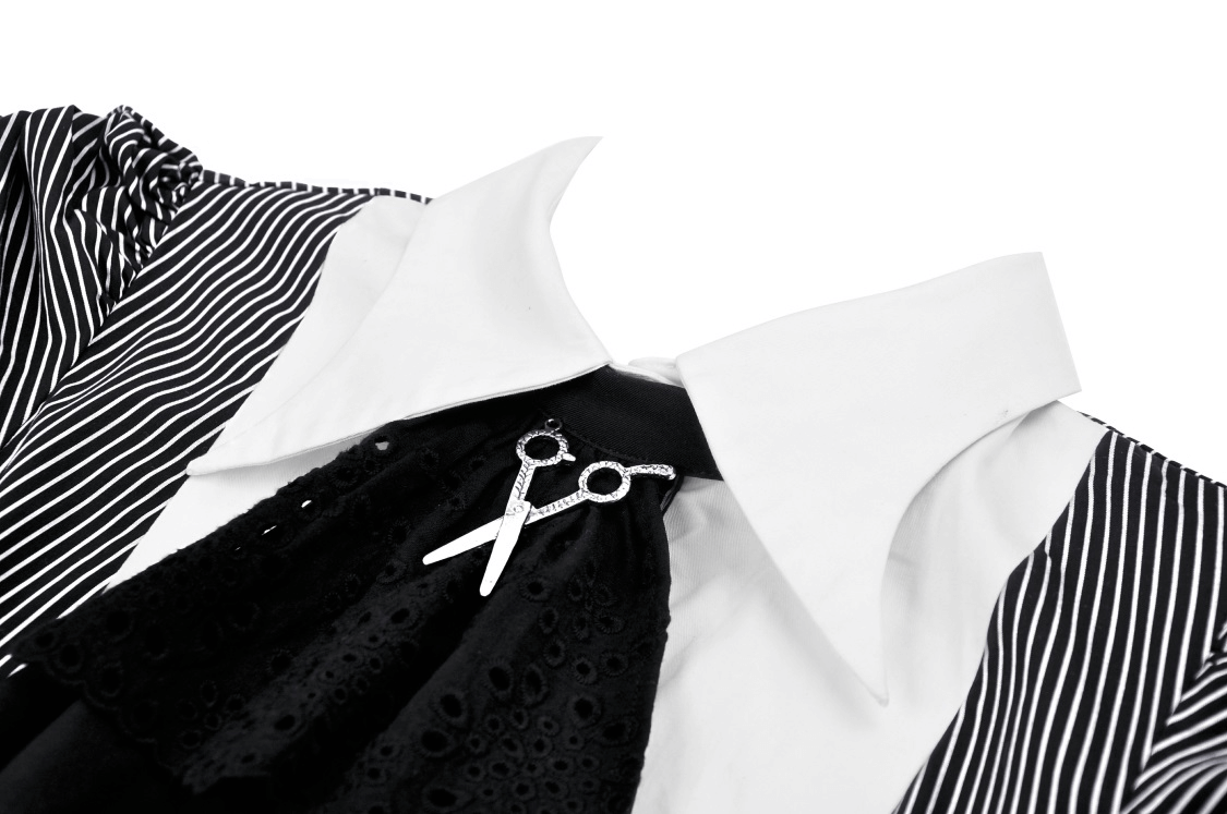 Close-up of a steampunk striped dress featuring ruffled sleeves, a bow tie, and a unique scissor brooch detail.