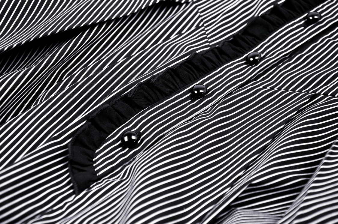 Close-up of a chic steampunk striped dress featuring ruffled sleeves and stylish buttons.