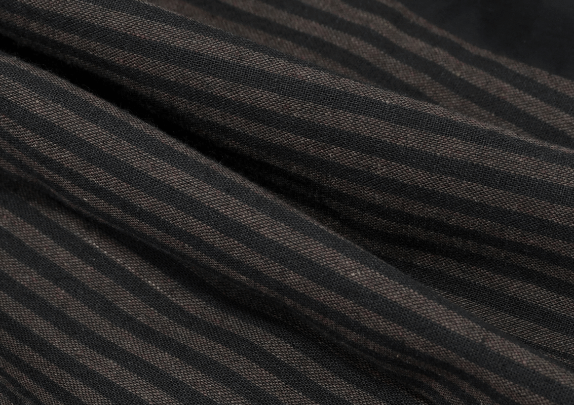 Close-up of vintage steampunk striped fabric in brown and black, perfect for a stylish women's long sleeves shirt.