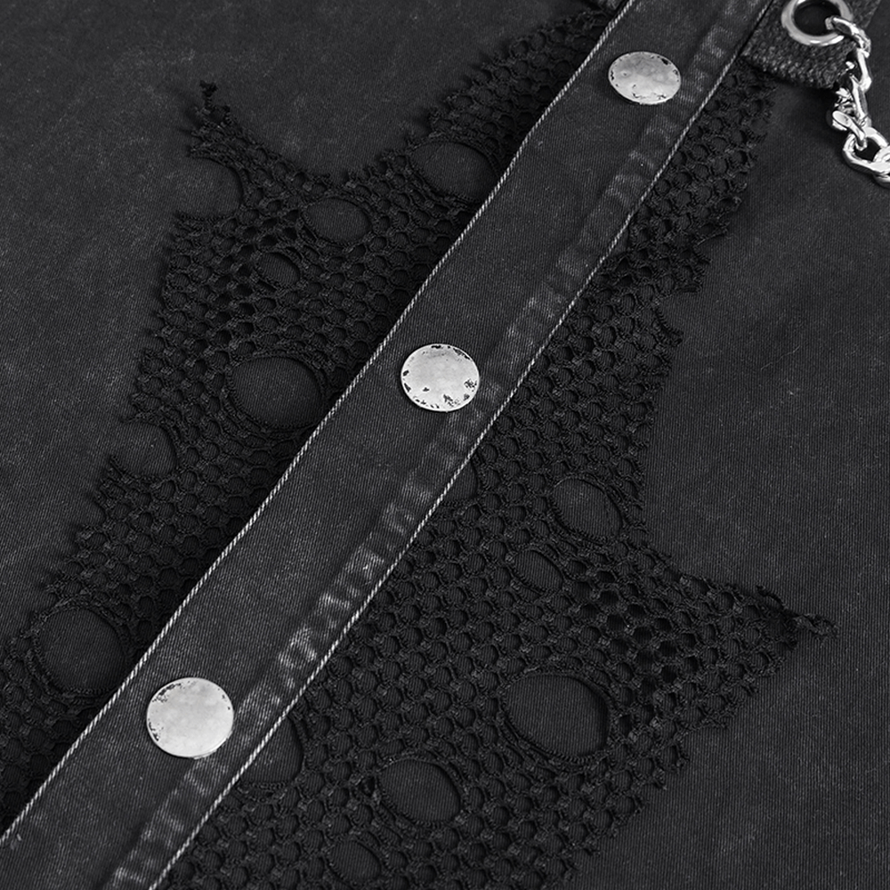 Close-up of steampunk black vest featuring lace detail, metal buttons, and rugged fabric.