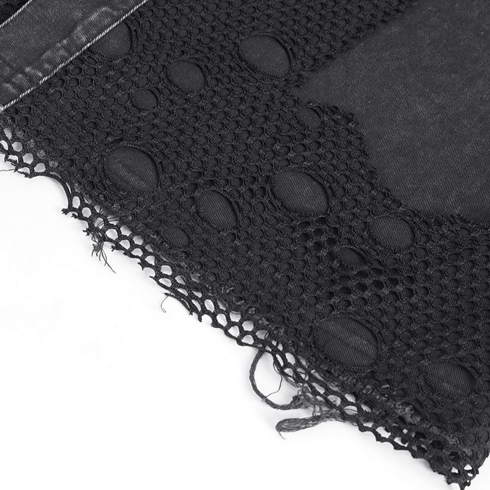 Close-up of the intricate lace detail and raw hem of a black steampunk vest, showcasing its edgy design and texture.