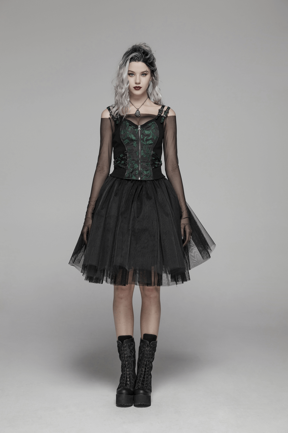 Victorian-inspired steampunk model in black jacquard waistcoat and tulle skirt, showcasing gothic style and elegance.