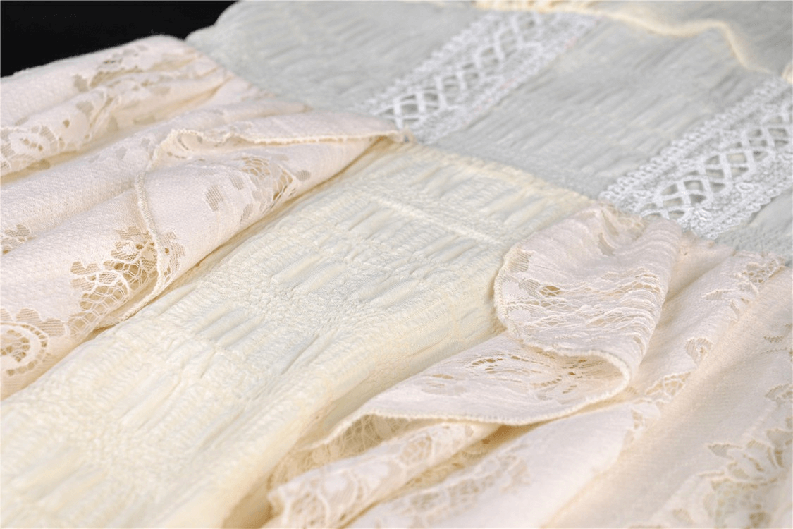 Close-up of intricate lace detailing on a vintage off-shoulder dress, showcasing soft textures and elegance.