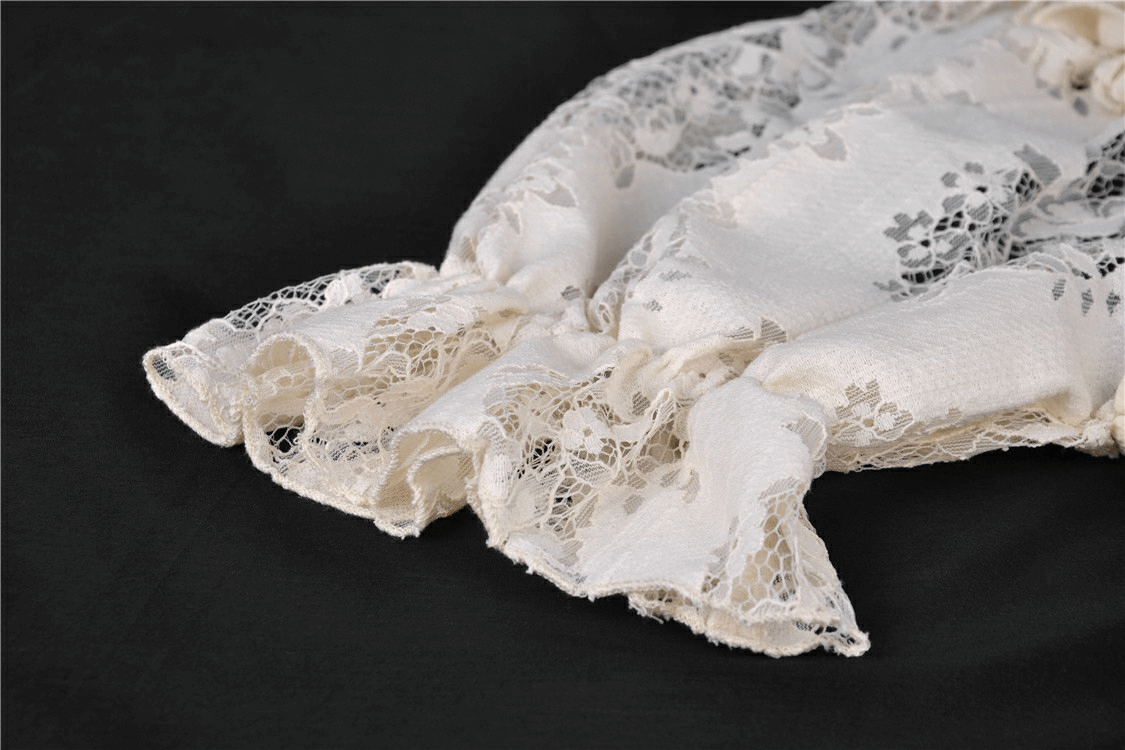 Close-up of delicate vintage lace with intricate patterns, showcasing the elegant fabric of a Victorian dress.