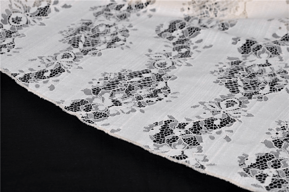 Elegant black and white vintage lace fabric close-up, showcasing intricate floral patterns perfect for steampunk designs.