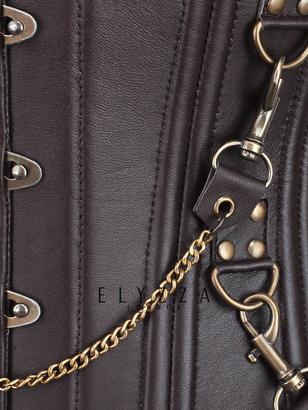 Close-up of a steampunk corset with gold chains and clasps, highlighting vintage-inspired details.