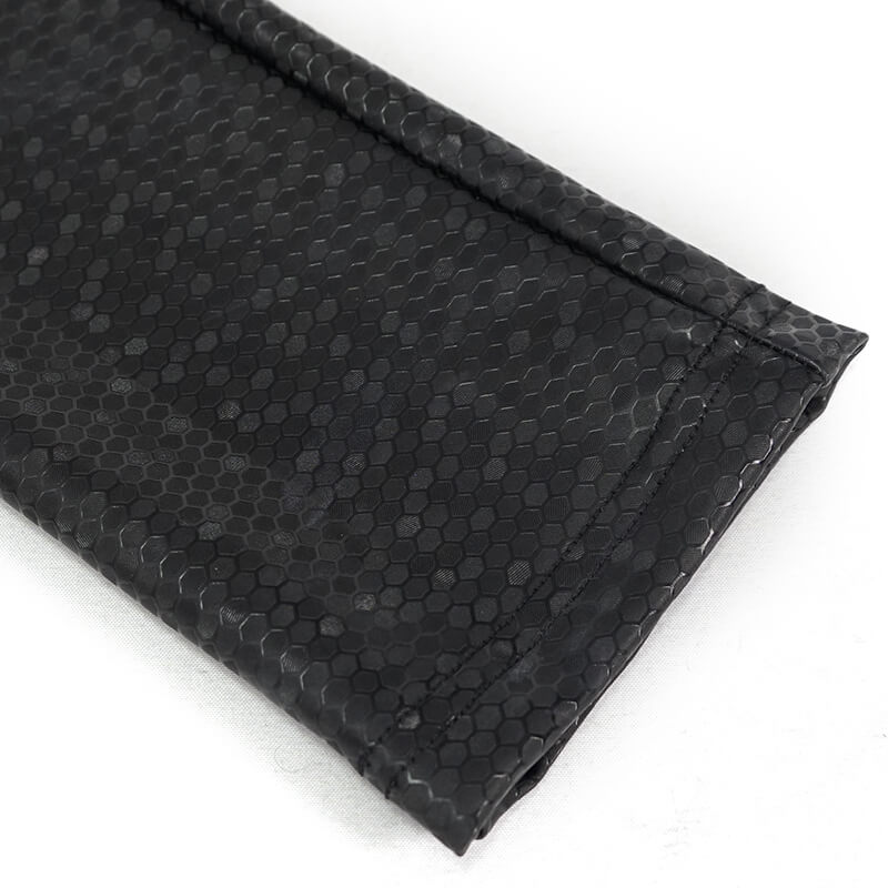 Close-up of black PU leather fabric with a stylish hexagon pattern for women's cyberpunk pants.