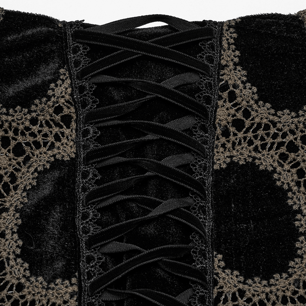 Close-up of black-brown lace detailing on a velvet gothic mini skirt, showcasing intricate lacing design.