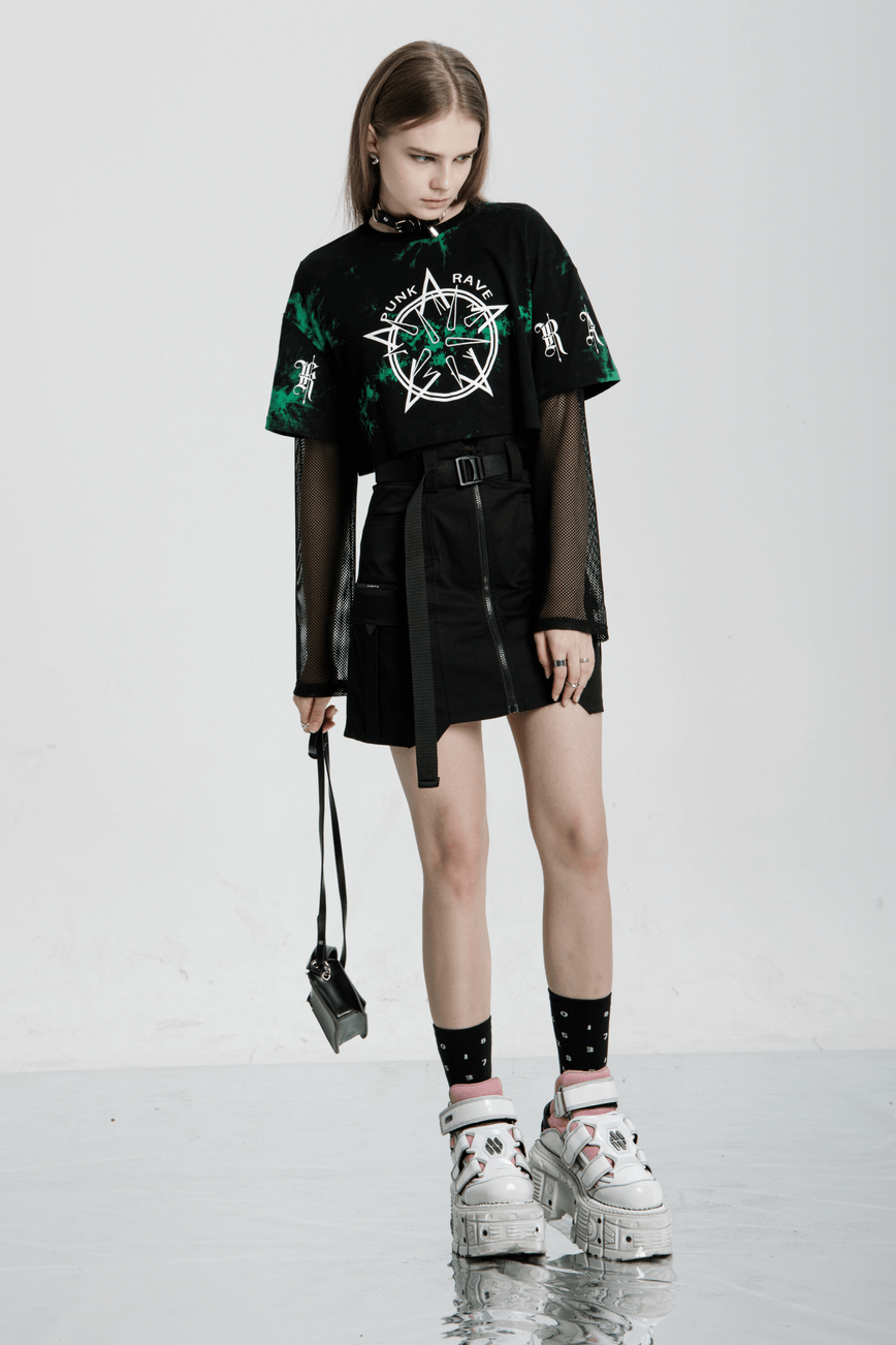 Model showcasing edgy rebel asymmetrical zippered tactical skirt with graphic tee and bold accessories.