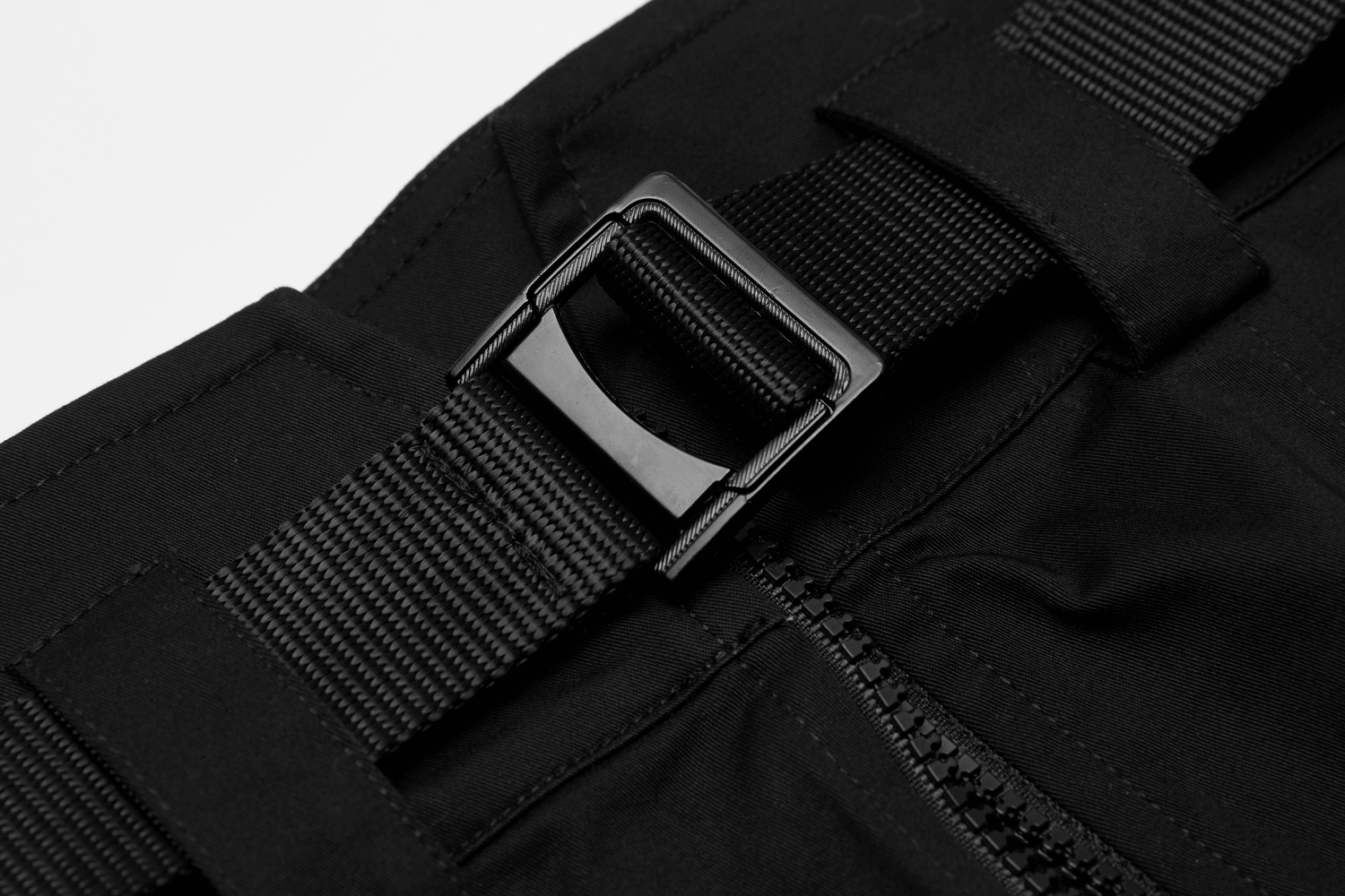 Close-up of high waist tactical skirt's black buckle and zipper detail for edgy streetwear style.