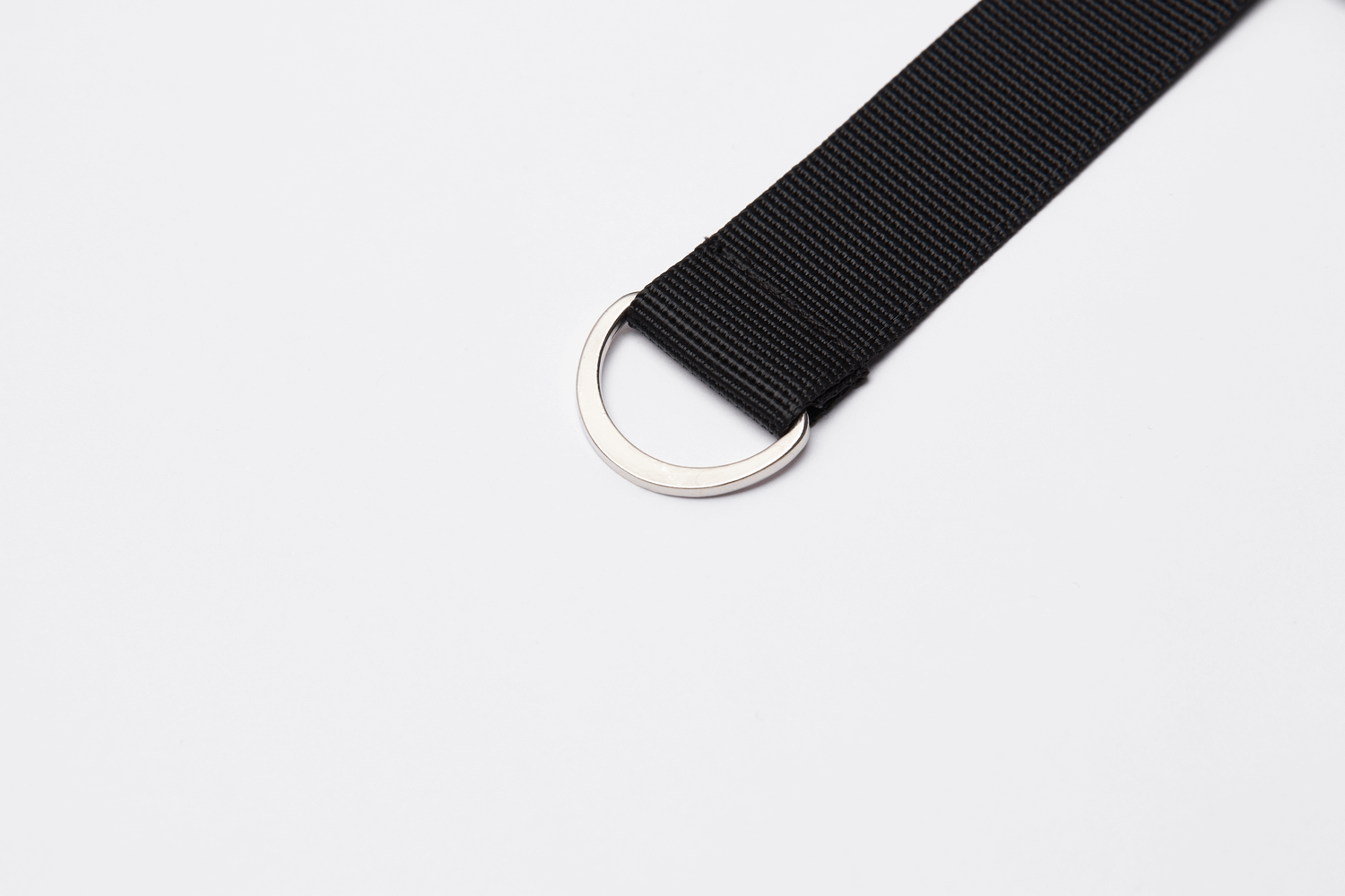 Customizable black fabric belt with a silver ring for edgy streetwear style.
