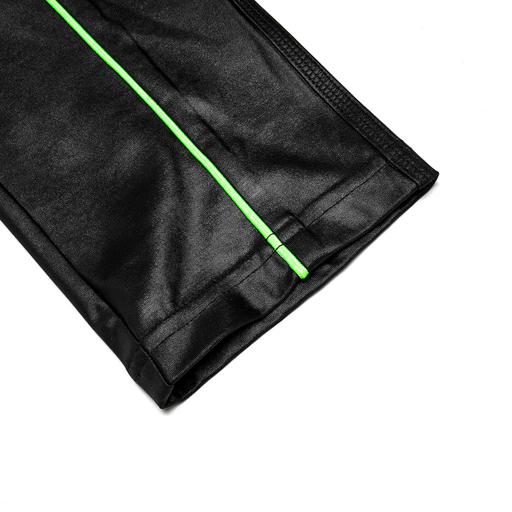 Close-up of stretch faux leather pants leg with bright green contrast stitching detail.