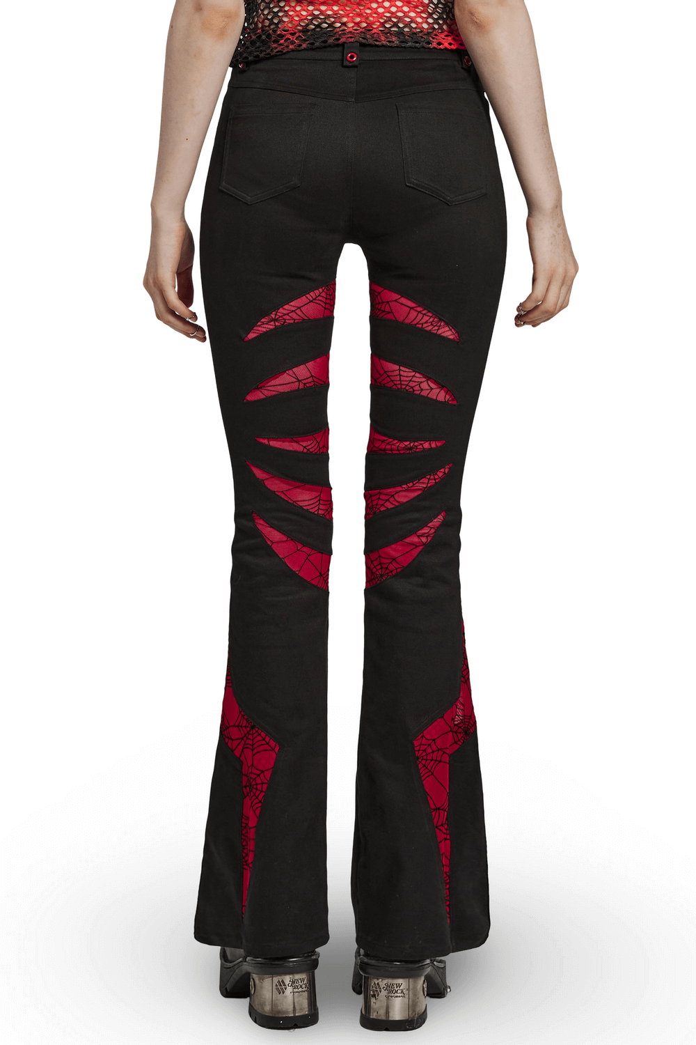 Back view of Gothic flared pants showing red spiderweb mesh details and skull accent button.
