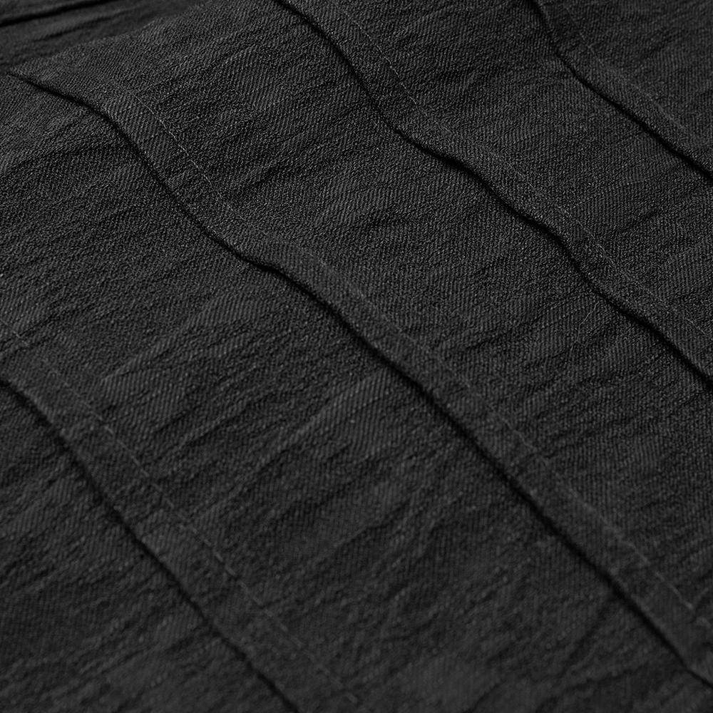 Close-up of stretch jacquard fabric showcasing intricate dark patterns for gothic elegance.
