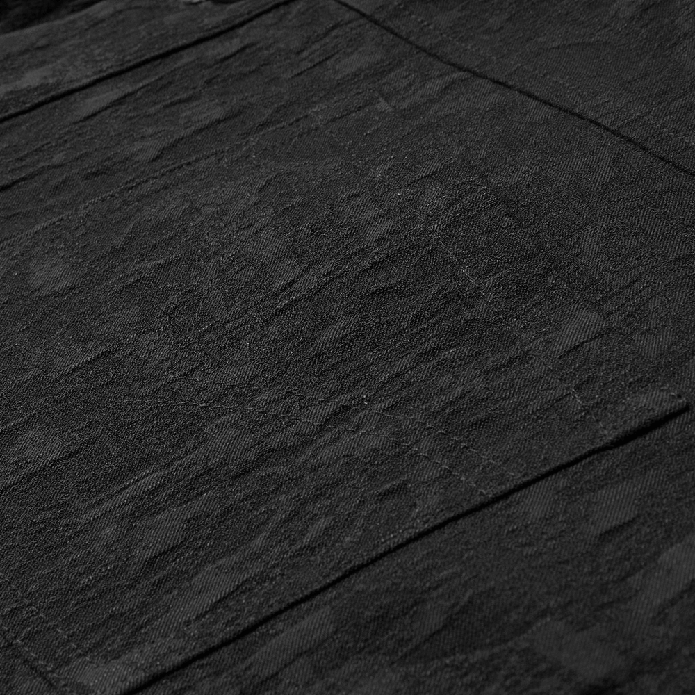 Close-up of stretch jacquard fabric showcasing intricate dark patterns for a gothic style shirt.