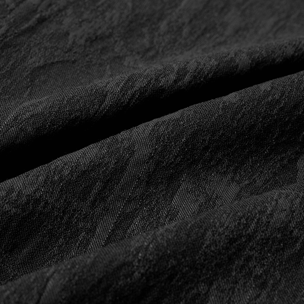 Close-up of stretch jacquard fabric in black, showcasing intricate patterns for a gothic aesthetic.