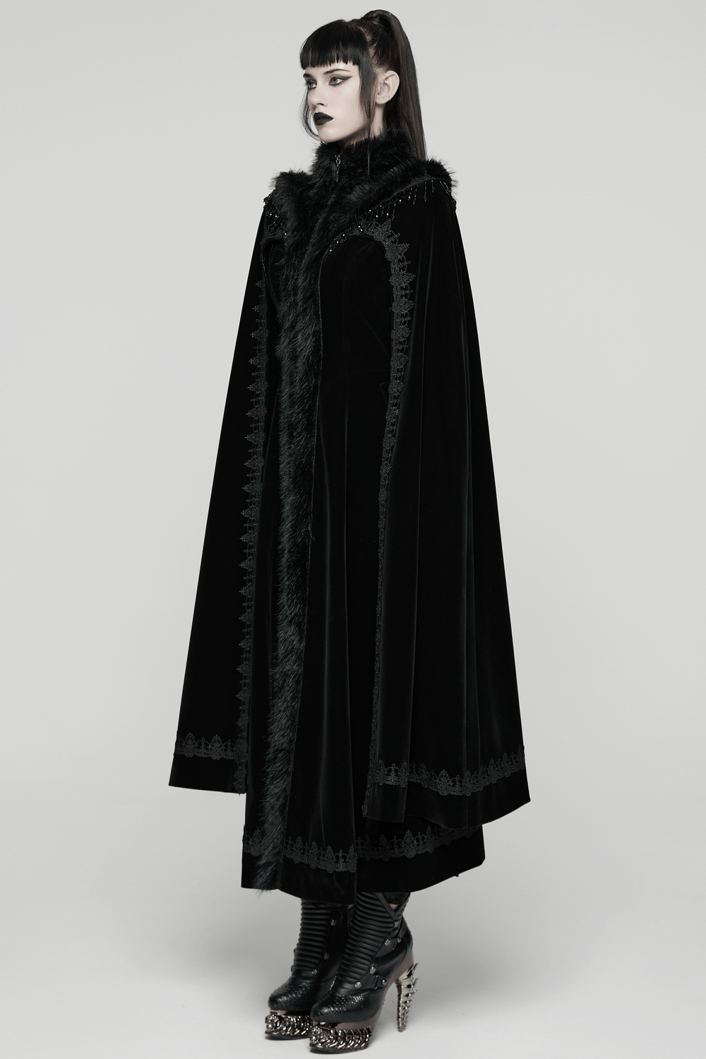 Striking Velvet Cloak Coat with Fur Trim and Tassel Chains worn by a model, showcasing gothic elegance and plush details.