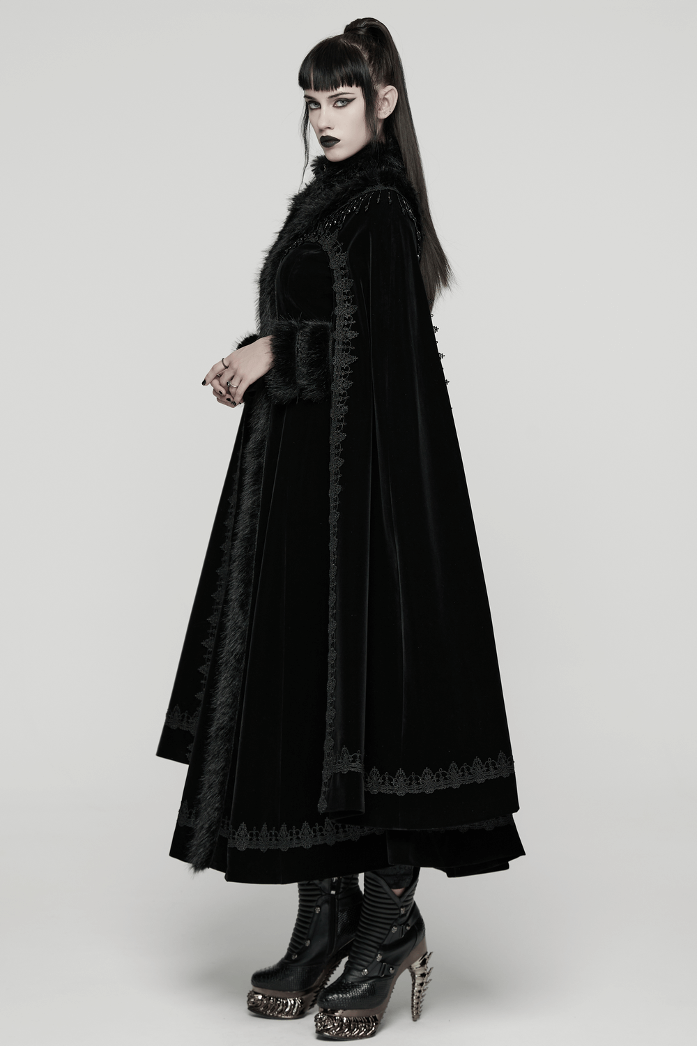 Striking Velvet Cloak Coat with Fur Trim and Tassel Chains worn by a model showcasing gothic elegance.