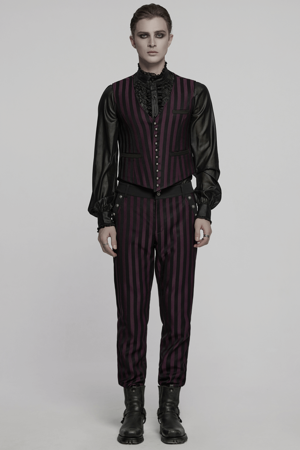 Gothic fashion model wearing striped black and burgundy slim trousers with a stylish vest and blouse.