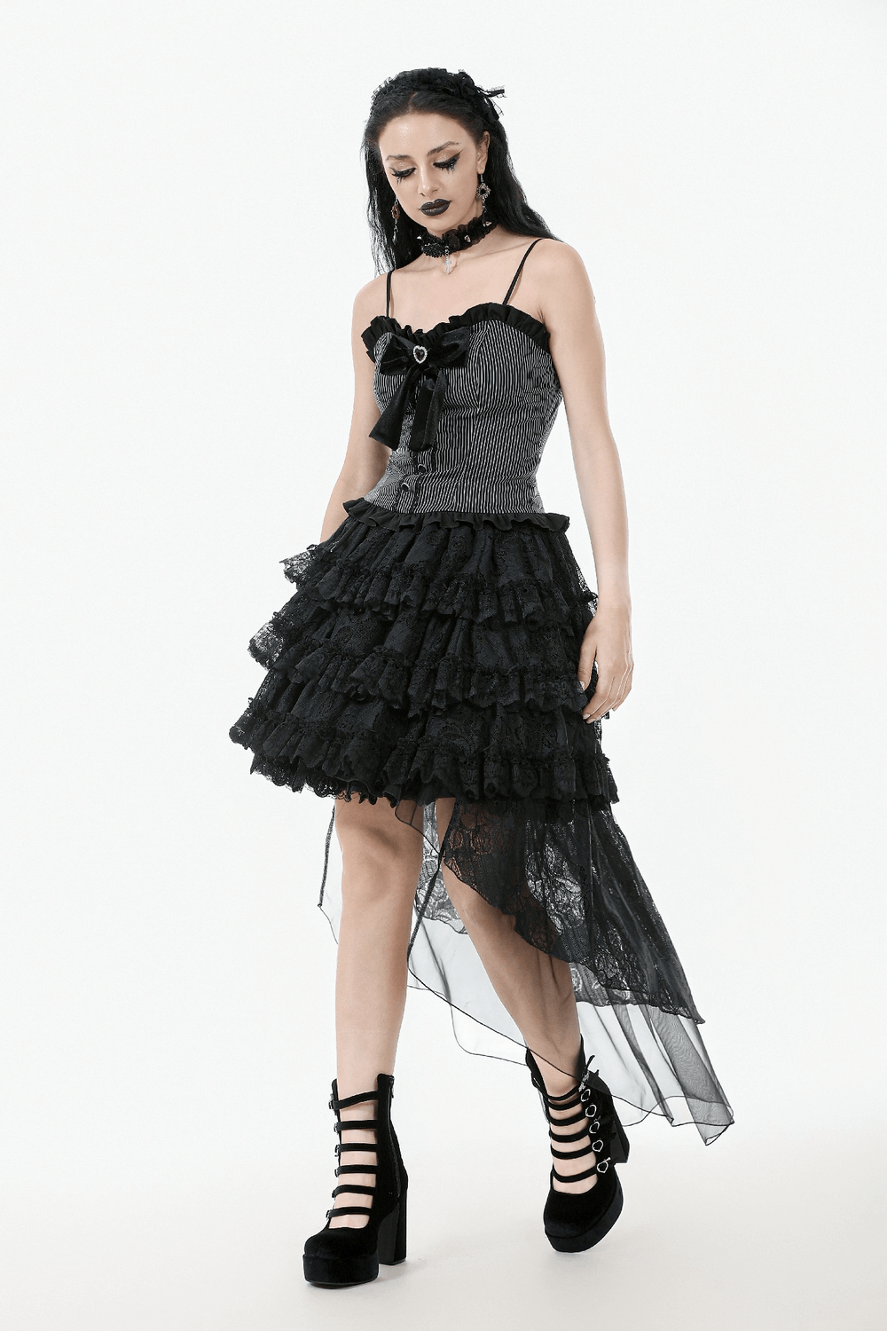 Chic black and white striped top with heart bow, lace-up back, and ruffled hem for vintage-inspired style.