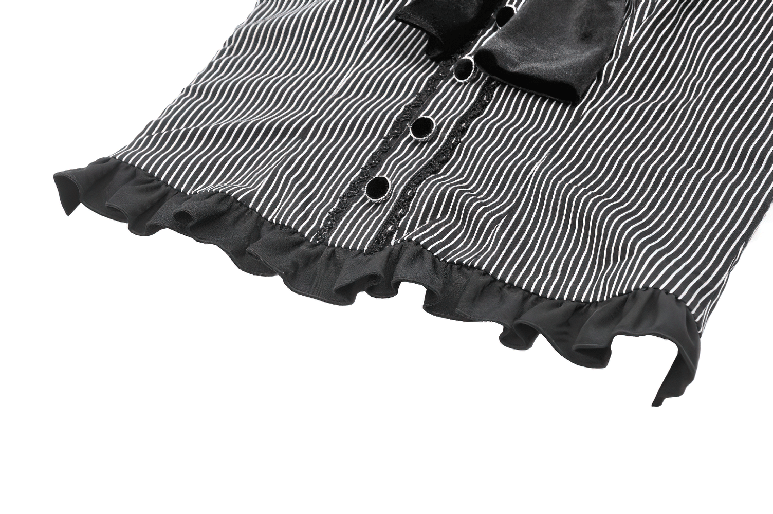 Close-up of a striped black and white top featuring a ruffled hem and heart-shaped bow detail.