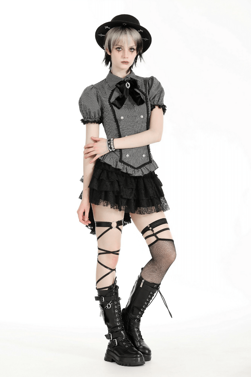 Stylish model in a grey striped Gothic blouse with bow, lace details, and ruffled skirt, showcasing bold fashion.