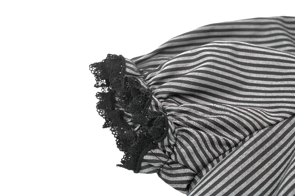 Close-up of striped Gothic blouse sleeve featuring black lace details and ruffled edge.