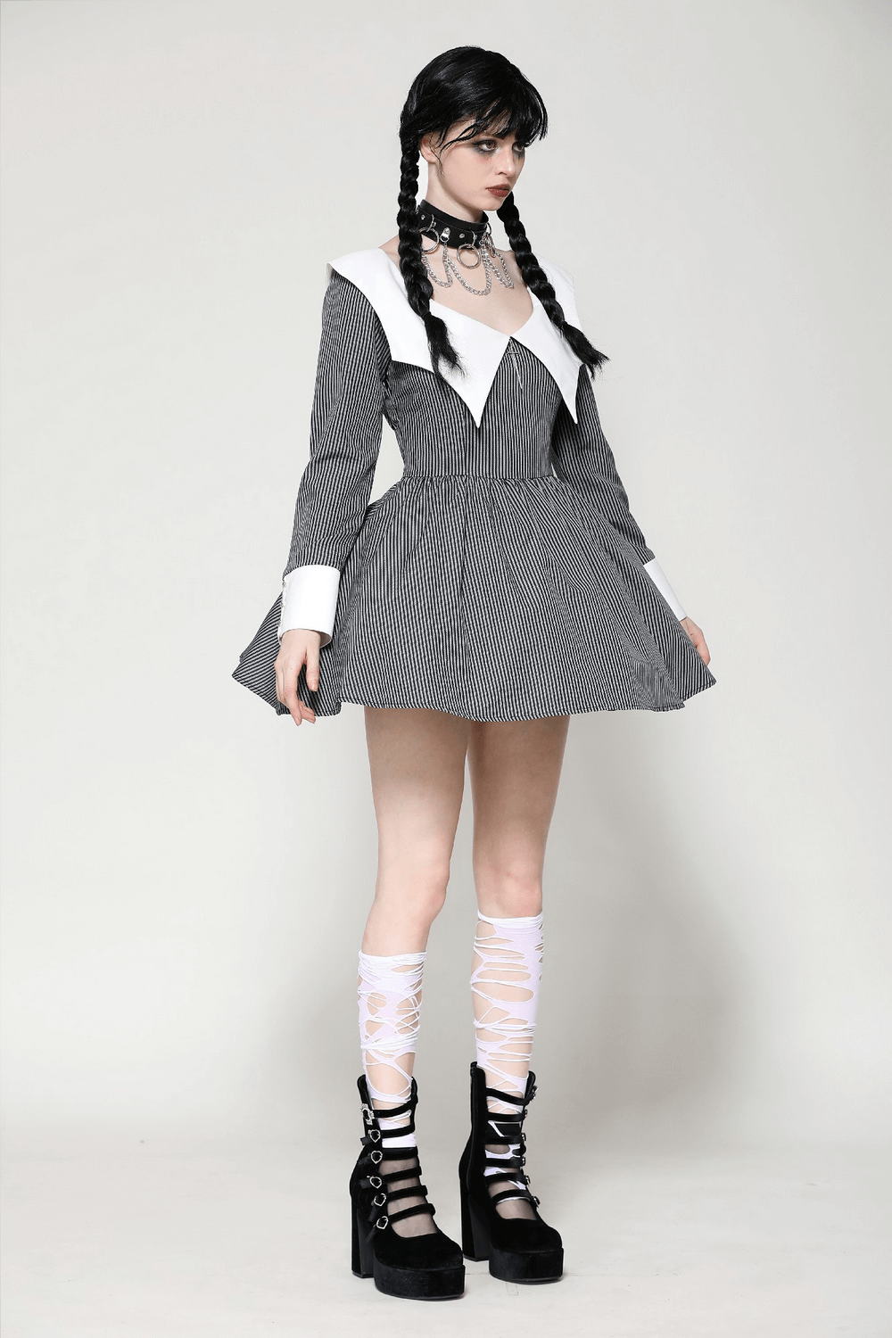 Striped long-sleeved dress with unique white collar and cuffs, featuring a flared skirt and stylish accessories.