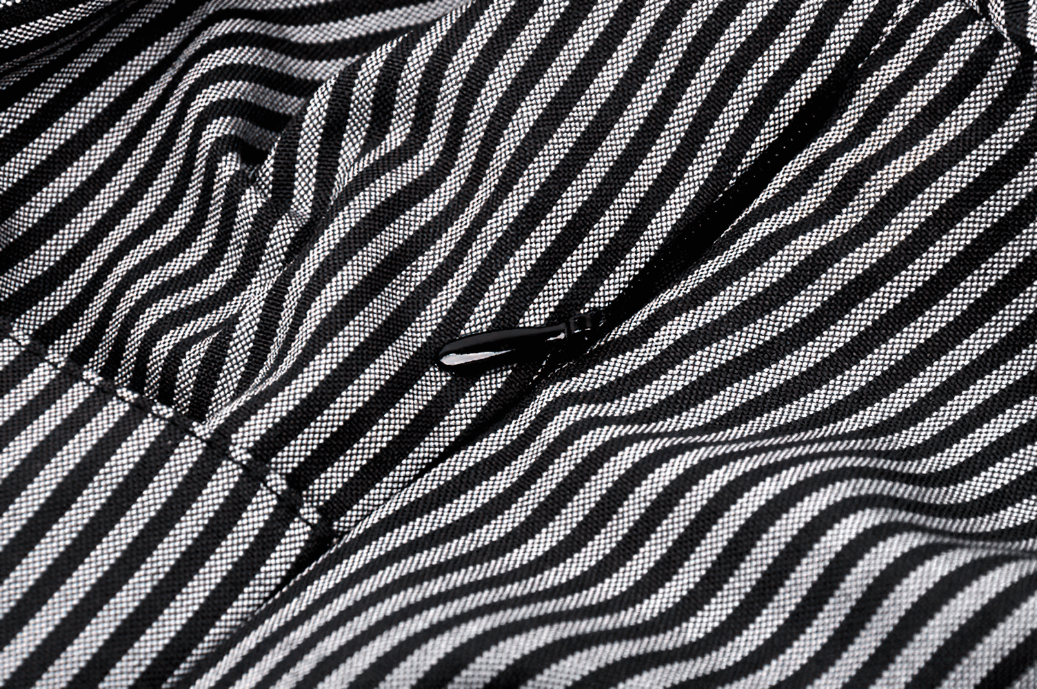 Close-up of striped fabric showcasing the elegant design of a long-sleeved dress with a unique collar.