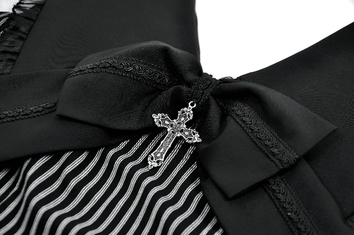 Close-up of the bow detail with a silver cross on the Striped Ruffle Dress with Bow and Lace-Up Back for Women.